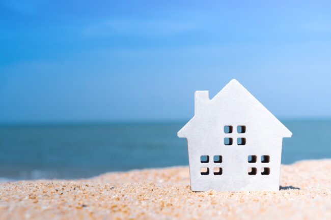 Closed,Up,Tiny,Home,Models,On,Sand,With,Sunlight,And